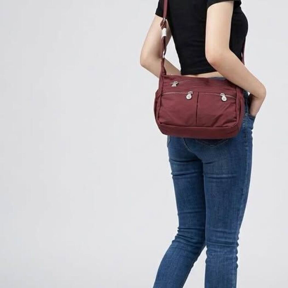 Water-resistant nylon lightweight crossbody bag with multiple zippered pockets